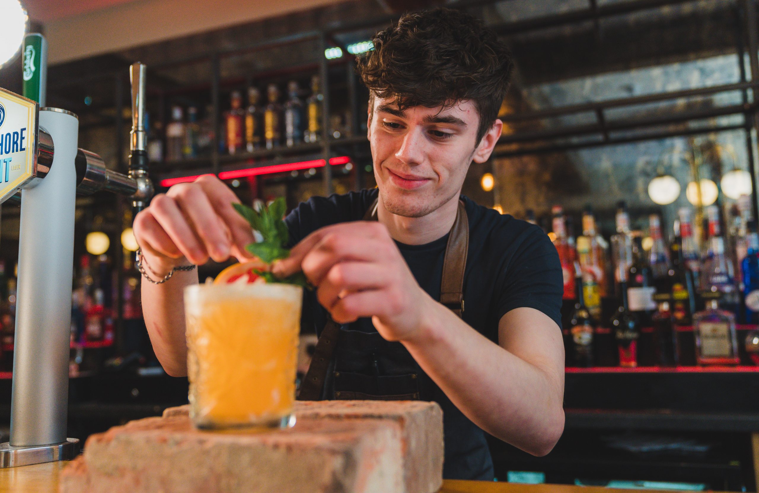 bartender finishing cocttail with a garnish at firehouse enniskillen