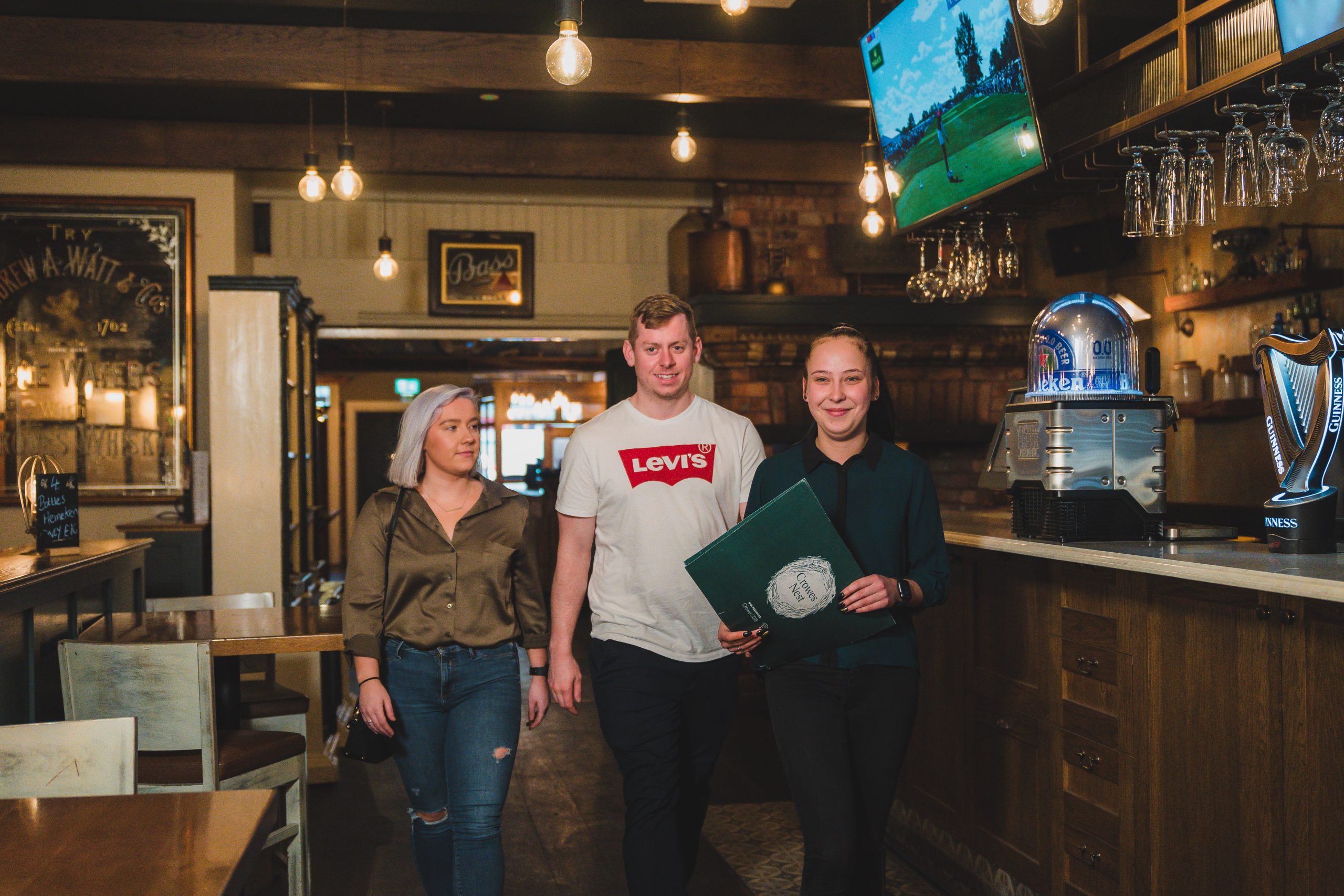 waitress at Crowes Nest walking couple to their table gluten free dining Enniskillen