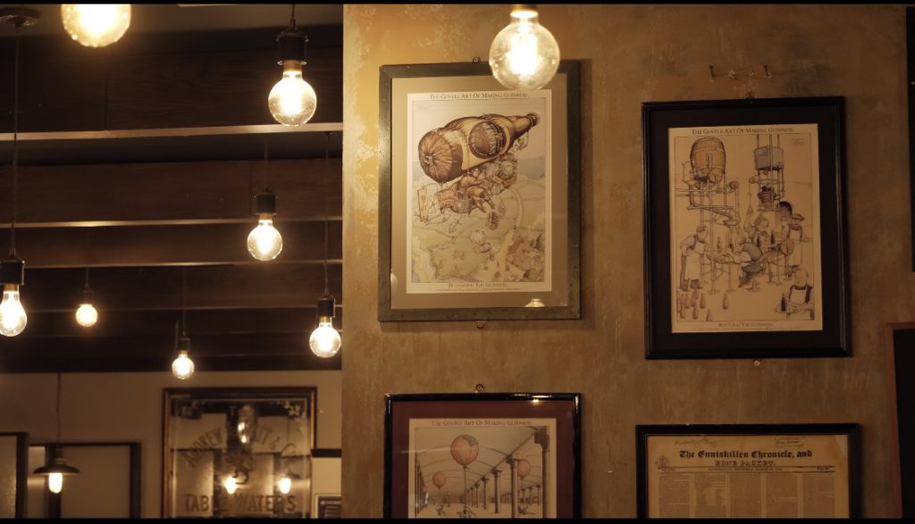 artwork and line drawings decorating the walls of the Crowes nest with exposure bulb pendants