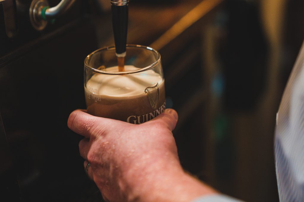 bartender pulling pint of guinness at crowes