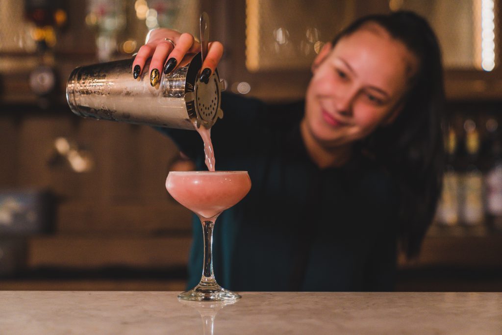bartender pourish cocktail from shaker at The Crowes Nest in Enniskillen