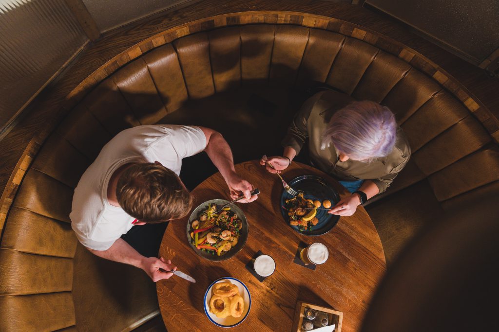 aerial shot of couple enjoying a delicious meal and cosy atmosphere at crowes Crowes Nest Food Reviews | Top Dishes & Dining Guide