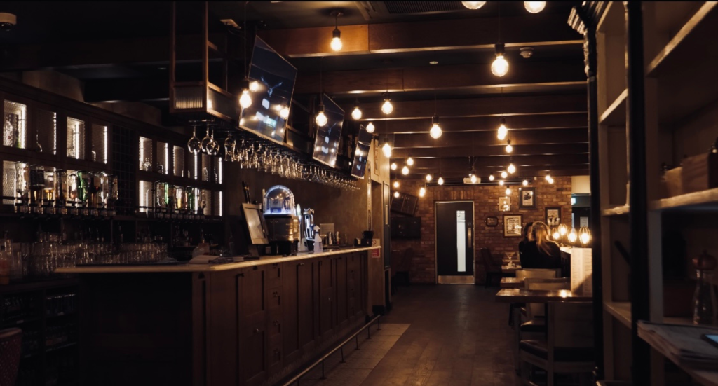bare bulb pendants hanging from exposed beams giving the crowes nest a cosy atmosphere for diners