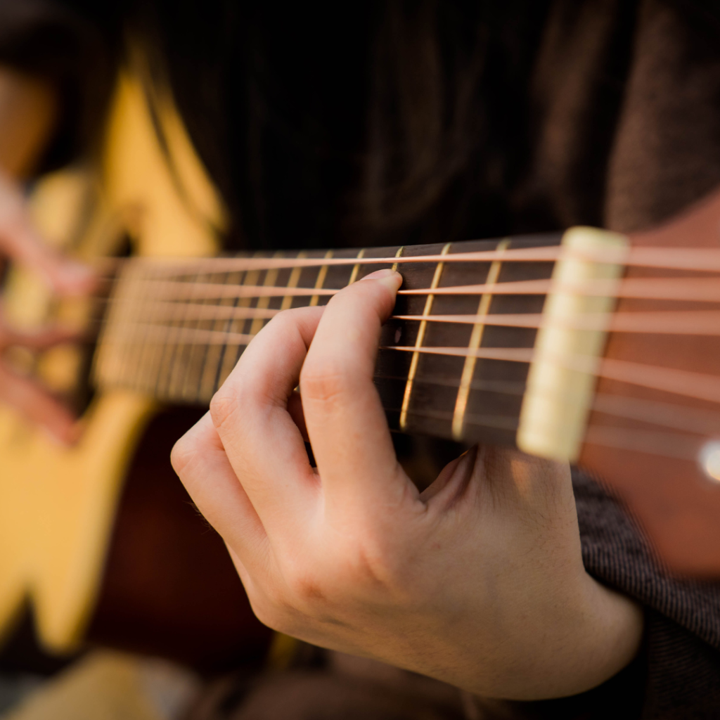 close up shot of hand playing guitar